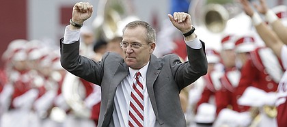 In this photo taken Sept. 6, 2014, former Arkansas athletic director Jeff Long walks onto the field before an NCAA college football game in Fayetteville, Ark. Long was announced as the 11th athletic director at the University of Kansas on Thursday, July 5, 2018.