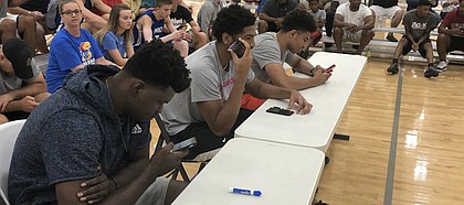 Current Jayhawks, from left to right, Udoka Azubuike, Dedric Lawson and Quentin Grimes showed up at Sports Pavilion Lawrence on Friday night and chipped in at the Hardwood Classic by judging the 2018 slam dunk contest. KU sophomore Marcus Garrett also helped hand out scores.