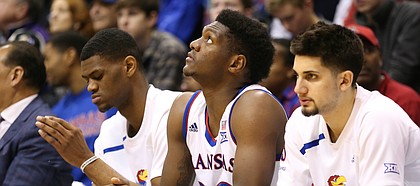 Kansas forward Silvio De Sousa (22) watches from the bench between Kansas forward Billy Preston, left, and Kansas guard Sam Cunliffe during the second half, Saturday, Jan. 13, 2018 at Allen Fieldhouse.