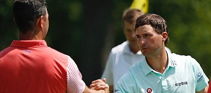 Gary Woodland, left, shakes hands with Kevin Kisner, right, on the ninth green after they finished the second round of the PGA Championship golf tournament at Bellerive Country Club, Friday, Aug. 10, 2018, in St. Louis. (AP Photo/Brynn Anderson)