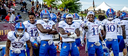 A contingent of Kansas football defensive players — from left, Elmore Hempstead Jr., Elijah Jones, Najee Stevens-McKenzie, Ricky Thomas, Mike Lee and Julian Chandler — pose on the sideline as the Jayhawks wrap up a road win at Central Michigan.