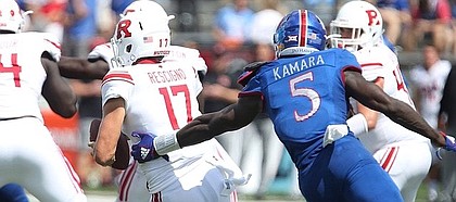 Kansas defensive end Azur Kamara (5) tries to get a hand on Rutgers quarterback Giovanni Rescigno (17) during the third quarter on Saturday, Sept. 15, 2018 at Memorial Stadium.