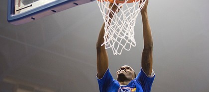 University of Kansas basketball senior Lagerald Vick grins while rising up for a slam during Late Night in the Phog, on Sept. 28, 2018, at Allen Fieldhouse.