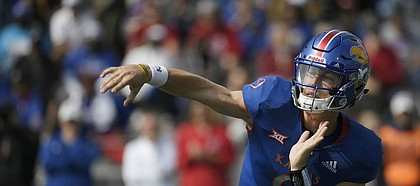 Kansas quarterback Carter Stanley throws a pass to a teammate at David Booth Kansas Memorial Stadium on Saturday, Sept. 29, 2018.