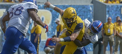 West Virginia quarterback Will Grier (7) fumbles the ball against Kansas during the second half of an NCAA college football game in Morgantown, W. Va., Saturday Oct. 6, 2018. (Craig Hudson/Charleston Gazette-Mail via AP)