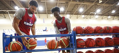Kansas forward Dedric Lawson, left, and guard Marcus Garrett grab a couple of European basketballs during an open practice on Tuesday, July 11, 2017.