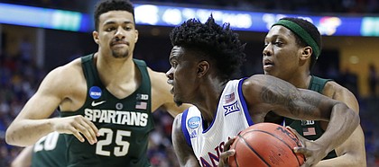 Kansas guard Lagerald Vick (2) drives to the bucket past Michigan State guard Cassius Winston (5) and Michigan State forward Kenny Goins (25) during the second half on Sunday, March 19, 2017 at BOK Center in Tulsa, Okla.