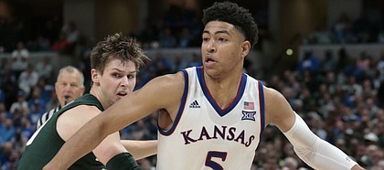 Kansas guard Quentin Grimes (5) goes around Michigan State guard Matt McQuaid (20) in the second half of an NCAA college basketball game at the Champions Classic on Tuesday, Nov. 6, 2018, in Indianapolis. Kansas won. 92-87.