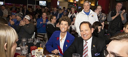 Newly-hired Kansas head football coach Les Miles sits next to his wife, Kathy, as they listen to Kansas Athletic Director Jeff Long tell a story about hiring Miles during the "Hawk Talk" radio show on Sunday, Nov. 18, 2018, at Johnny's West in Lawrence. Miles was announced as the head coach earlier in the day.