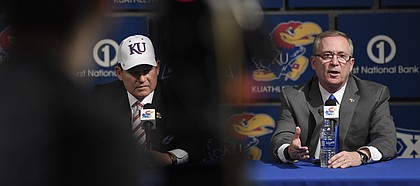 Kansas Athletics Director Jeff Long, right, answers a question at a press conference introducing new football coach Les Miles, left, on Sunday, Nov. 18, 2018, at Hadl Auditorium.