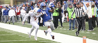 Kansas running back Pooka Williams Jr. (1) leaves Texas defensive back Caden Sterns (7) behind as he skips into the end zone for a touchdown during the fourth quarter on Friday, Nov. 23, 2018 at Memorial Stadium.