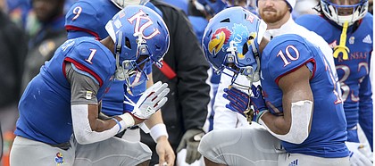 Kansas running back Pooka Williams Jr. (1) and Kansas running back Khalil Herbert (10) celebrate a touchdown by Williams by bowing to each other during the fourth quarter on Friday, Nov. 23, 2018 at Memorial Stadium.