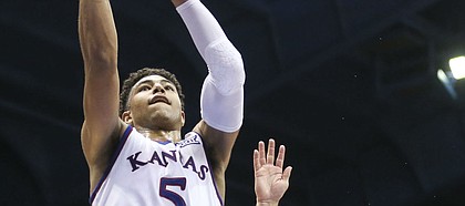 Kansas guard Quentin Grimes (5) soars in for a bucket past Wofford guard Nathan Hoover (10) during the second half on Tuesday, Dec. 4, 2018 at Allen Fieldhouse.