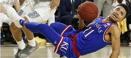 Kansas guard Devon Dotson (11) loses the ball in front of Arizona State guard Rob Edwards during the first half of an NCAA college basketball game Saturday, Dec. 22, 2018, in Tempe, Ariz. (AP Photo/Rick Scuteri)