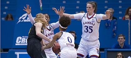 Kansas' Christalah Lyons (0), Austin Richardson (14), and Bailey Helgren (35) trap Vermont's Hanna Crymble (10) for a steal in the first quarter on Sunday, Dec. 30, 2018 at Allen Fieldhouse.
