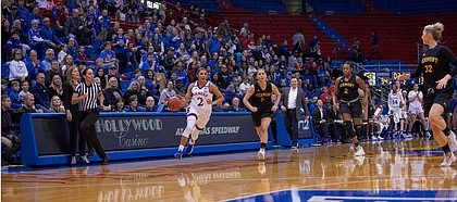 Kansas guard Brianna Osorio (2) races down the court to beat the final second in the half as Vermont's Josie Larkins (5) and Carmen Handy (32) try to guard her on Sunday, Dec. 30, 2018 at Allen Fieldhouse.