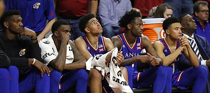 Kansas players watch from the bench during the second half of an NCAA college basketball game against Iowa State, Saturday, Jan. 5, 2019, in Ames, Iowa.