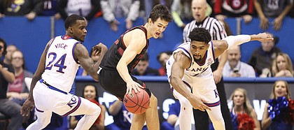 Kansas guard Lagerald Vick (24) and Kansas forward Dedric Lawson (1) look to pressure Stanford guard Cormac Ryan (23) during the second half on Saturday, Dec. 1, 2018 at Allen Fieldhouse.
