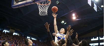 Kansas forward Mitch Lightfoot (44) puts up a shot over several Oklahoma State players during the second half, Saturday, Feb. 9, 2019 at Allen Fieldhouse.