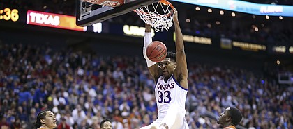 Kansas forward David McCormack (33) puts down a dunk against Texas during the first half, Thursday, March 14, 2019 at Sprint Center in Kansas City, Mo.