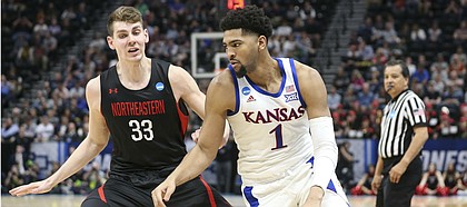 Kansas forward Dedric Lawson (1) looks to drive against Northeastern forward Tomas Murphy (33) during the second half, Thursday, March 21, 2019 at Vivint Smart Homes Arena in Salt Lake City, Utah.