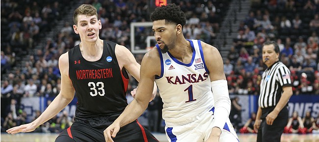 Kansas forward Dedric Lawson (1) looks to drive against Northeastern forward Tomas Murphy (33) during the second half, Thursday, March 21, 2019 at Vivint Smart Homes Arena in Salt Lake City, Utah.