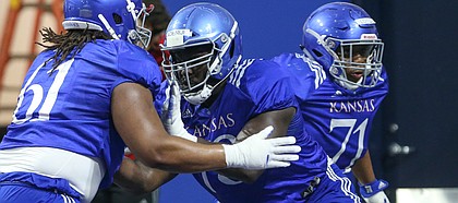 Kansas offensive lineman Hakeem Adeniji works against fellow lineman Malik Clark (61) on Thursday, April 4, 2019 at the indoor practice facility.