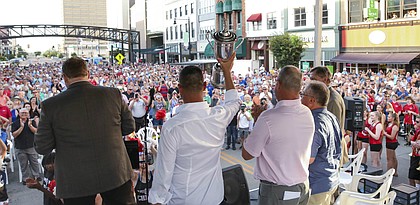 Golfer Gary Woodland hoists the U.S. Open Championship trophy as he takes the stage during a block party along Kansas Ave. in Topeka on Tuesday, July 2, 2019. Woodland, who recently won the U.S. Open at Pebble Beach, was celebrated in his home town.