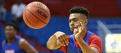 Kansas newcomer Issac McBride throws a pass during a scrimmage on Tuesday, June 11, 2019 at Allen Fieldhouse.