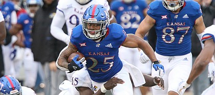 Blue team running back Dom Williams tries to break free of a tackle during Late Night Under the Lights on Saturday, April, 13, 2019 at Memorial Stadium.