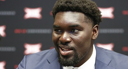 Kansas senior offensive lineman Hakeem Adeniji speaks to the media on the first day of Big 12 NCAA college football media days Monday, July 15, 2019, at AT&T Stadium in Arlington, Texas. (AP Photo/David Kent)