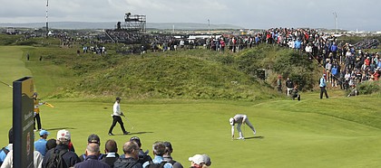 Gary Woodland of the United States picks his ball out of the 4th green during the first round of the British Open Golf Championships at Royal Portrush in Northern Ireland, Thursday, July 18, 2019.
