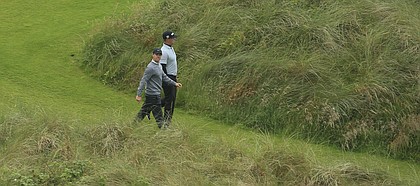 Northern Ireland's Rory McIlroy, left looks up as he walks from the 7th tee with Gary Woodland of the United States during the second round of the British Open Golf Championships at Royal Portrush in Northern Ireland, Friday, July 19, 2019.