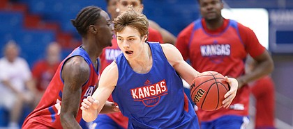 Kansas newcomer Christian Braun drives past Kansas guard Marcus Garrett during a scrimmage on Tuesday, June 11, 2019 at Allen Fieldhouse.