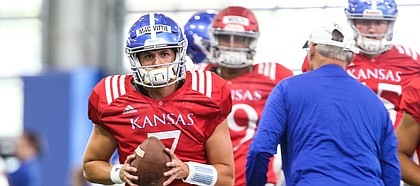 Kansas quarterback Thomas MacVittie pulls back to pass during practice on Thursday, Aug. 8, 2019.