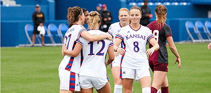 KU teammates Sophie Maierhofer (27), Katie McClure (12) and Ebba Costow (8) celebrate a goal during the team's 6-0 win over Loyola Chicago Sunday afternoon at Rock Chalk Park on Aug. 25, 2019.