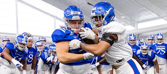 Kansas fullback Ben Miles, left, and linebacker Dru Prox go head-to-head in the Jayhawk drill during practice on Thursday, Aug. 8, 2019.