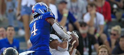 Coastal Carolina cornerback Chandler Kryst (13) intercepts a pass intended for Kansas wide receiver Andrew Parchment (4) during the first half of an NCAA college football game in Lawrence, Kan., Saturday, Sept. 7, 2019. (AP Photo/Orlin Wagner)