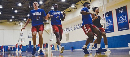 KU grad transfer Isaiah Moss, second from left, runs sprints with his teammates during boot camp in the KU practice gym earlier this week.