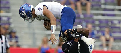 Kansas Jayhawks quarterback Carter Stanley (9) tries to leap over TCU Horned Frogs safety Trevon Moehrig (7) in the fourth quarter as the Kansas Jayhawks play the TCU Horned Frogs at Amon Carter Stadium in Fort Worth, Texas Saturday, Sept. 28, 2019. (David Kent/Star-Telegram via AP)