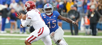 Kansas linebacker Kyron Johnson (15) chases Oklahoma quarterback Jalen Hurts (1) during the first quarter on Saturday, Oct. 5, 2019 at Memorial Stadium.