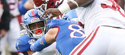 Kansas running back Pooka Williams Jr. (1) is put on the turf by the Oklahoma defense on a run in the first quarter on Saturday, Oct. 5, 2019 at Memorial Stadium.