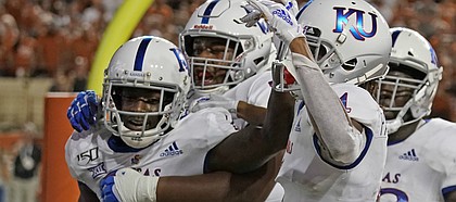 Kansas' Daylon Charlot (2) celebrates with teammates after catching a 2-point conversion during the second half of the team's NCAA college football game against Texas in Austin, Texas, Saturday, Oct. 19, 2019.