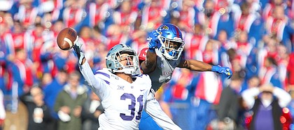 Kansas State defensive back Jahron McPherson (31) disrupts a pass to Kansas wide receiver Stephon Robinson Jr. (5) during the second quarter on Saturday, Nov. 2, 2019 at Memorial Stadium.