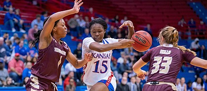 KU freshman guard Zakiyah Franklin (15) tries to drive dribble pass Texas State Avionne Alexander (1) and Bailey Holly (33). KU defeated Texas State 68-48 on Sunday, Nov. 24.