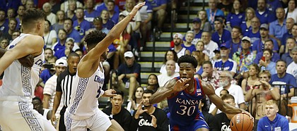 Kansas guard Ochai Agbaji (30) dribbles through the Chaminade defense during an NCAA college basketball game Monday, Nov. 25, 2019, in Lahaina, Hawaii. (AP Photo/Marco Garcia)