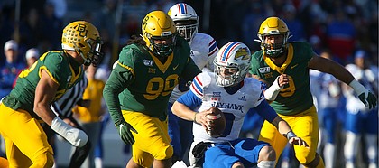 Three Baylor defenders close in on Kansas quarterback Carter Stanley (9) during the first quarter on Saturday, Nov. 30, 2019 at Memorial Stadium.