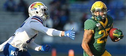 Baylor Bears running back Trestan Ebner (25) escapes Kansas cornerback Hasan Defense (13) during a run in the second quarter on Saturday, Nov. 30, 2019 at Memorial Stadium.