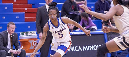 Kansas sophomore Aniya Thomas (5) makes a move to drive to the rim during KU's nonconference finale Monday night at Allen Fieldhouse on Dec. 30, 2019.