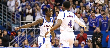 Kansas Jayhawks guard Marcus Garrett (0) and Kansas Jayhawks guard Isaiah Moss (4) slap hands after a three from Moss during the first half on Saturday, Jan. 11, 2020 at Allen Fieldhouse.